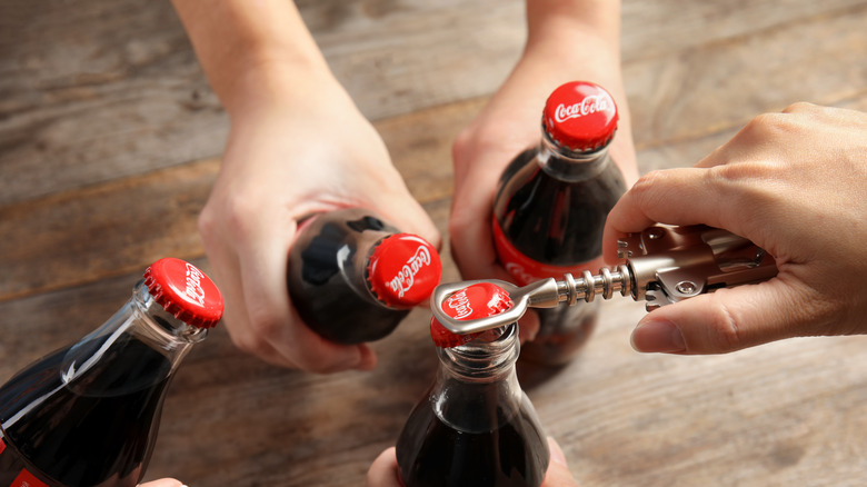 Group opening glass coke bottles