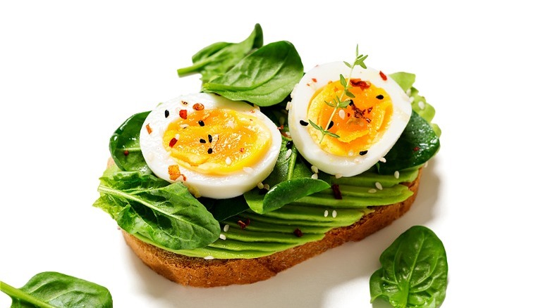 Sliced egg and greens on toast