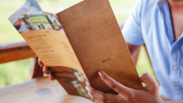 person looking at menu