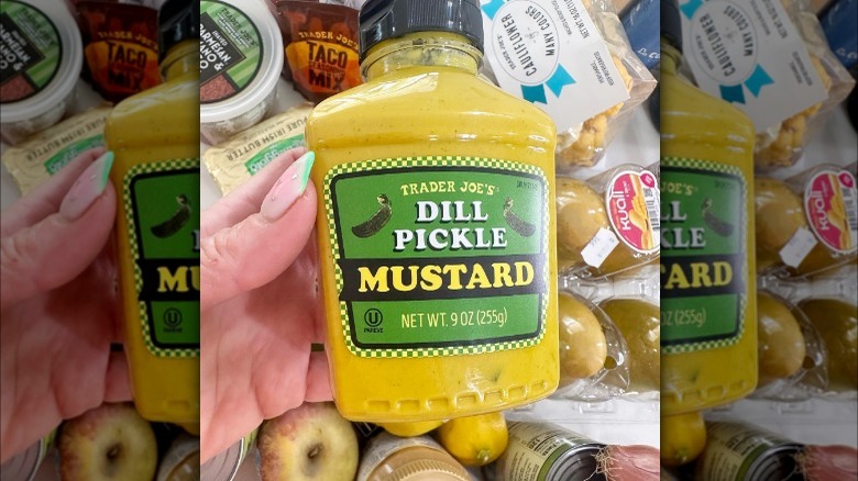 Person holds a jar of Trader Joe's dill pickle mustard