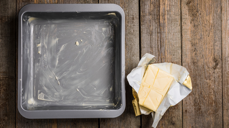 A metal baking pan greased with butter