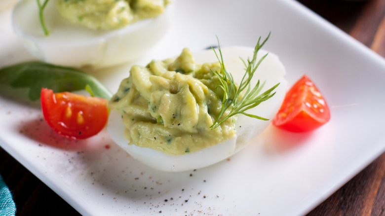 Avocado deviled eggs with tomatoes