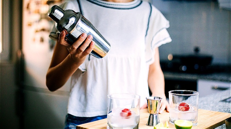 Person holding cocktail shaker