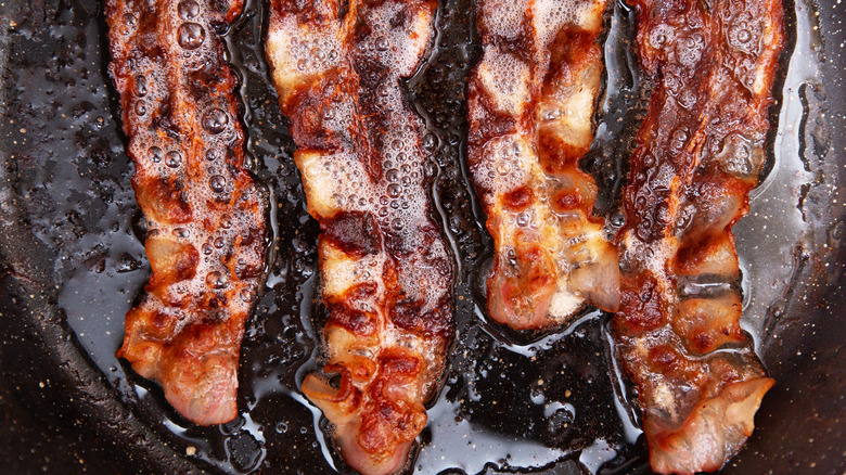 bacon sizzling in pan