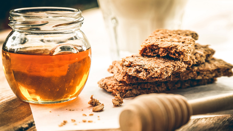 Pot of honey with cookies