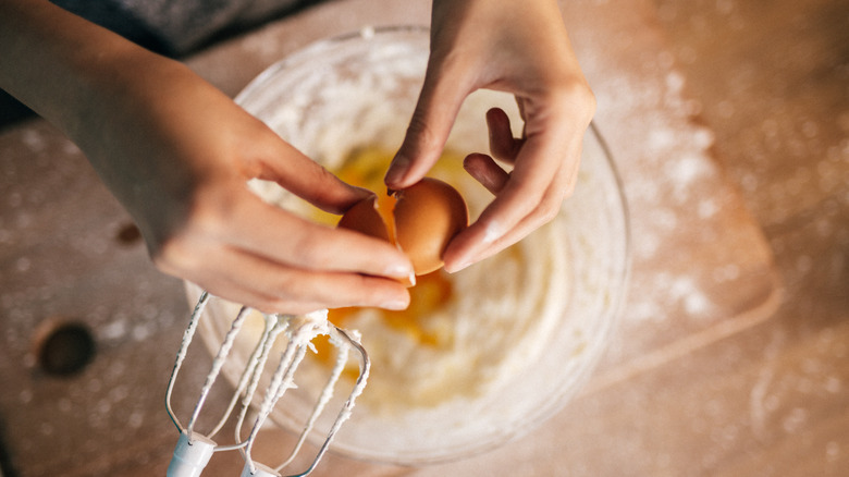 Cracking an egg into a bowl