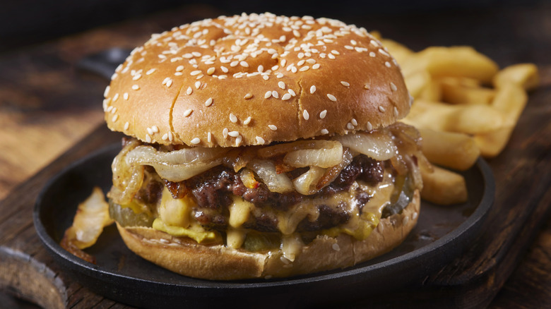 A burger topped with caramelized onions