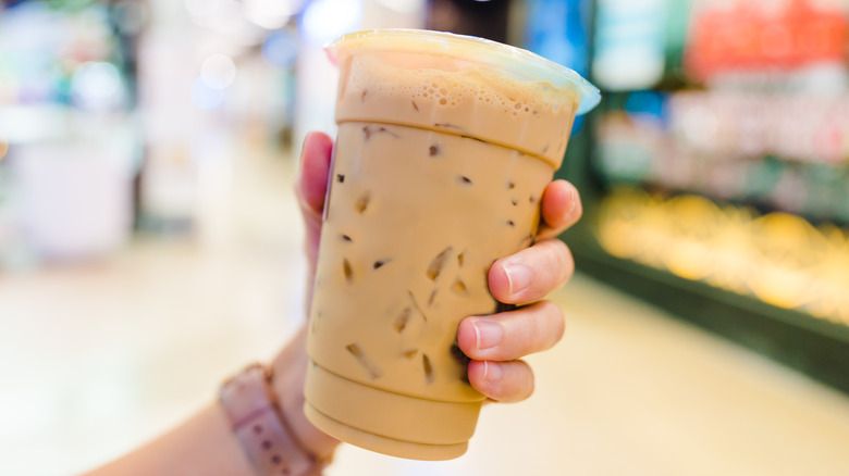 person holding iced milk tea