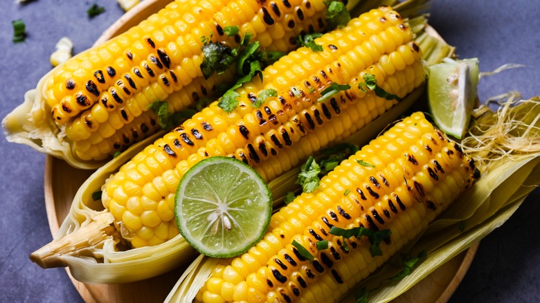 Grilled corn in husk with lime