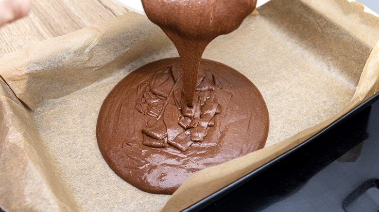 Pouring cake batter into sheet pan