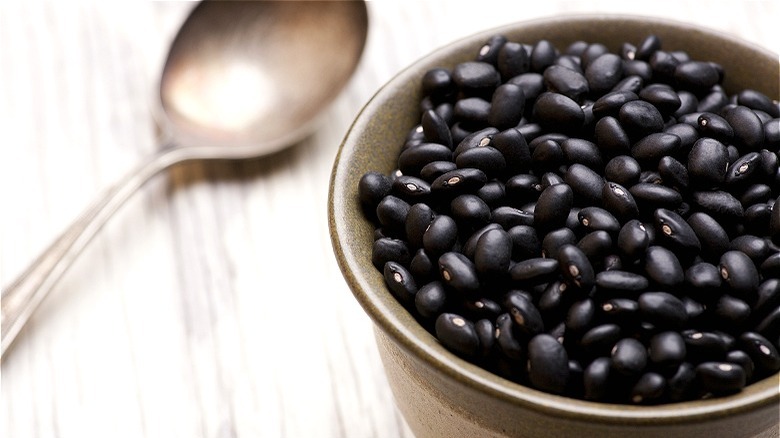 Black beans in bowl with spoon 