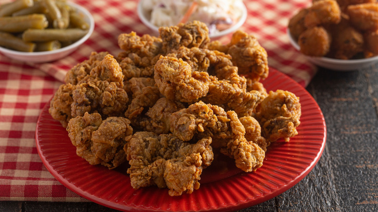 Fried chicken gizzards on red plate