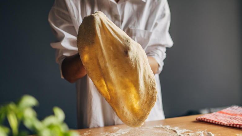 Woman stretching dough