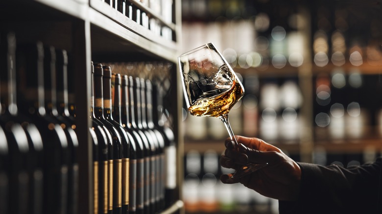 White wine being swirled in wine shop