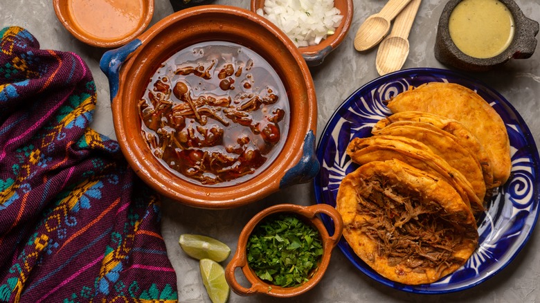 Birria broth with tacos