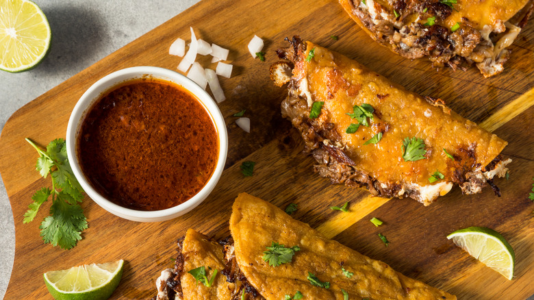 Birria broth and tacos