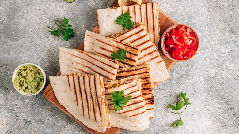 Quesadillas on wooden cutting board 