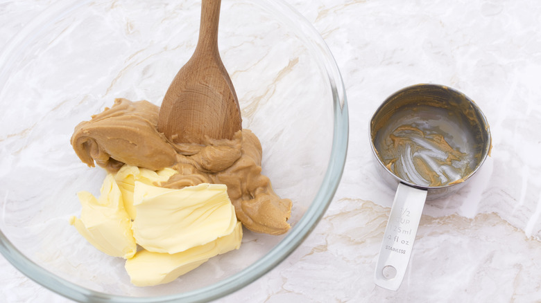 Peanut butter in a bowl and measuring cup