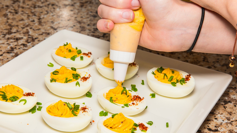 hand piping yolk for deviled eggs