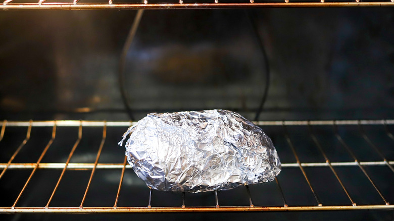 baked potato wrapped in foil in oven