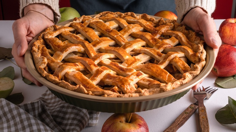 woman holding an apple pie