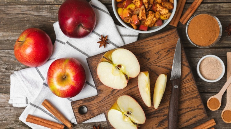 apples and spices on cutting board