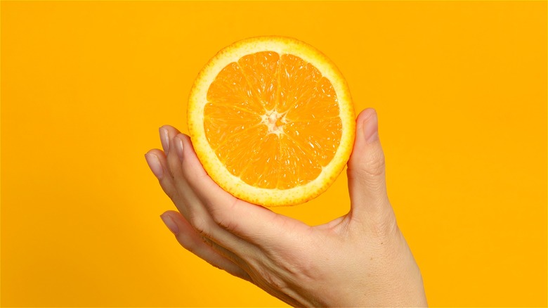 Hand holding cut orange 