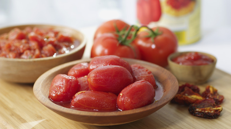 Peeled and chopped Roma tomatoes in a wooden bowl