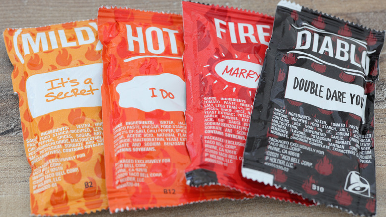 Four assorted Taco Bell hot sauce packets