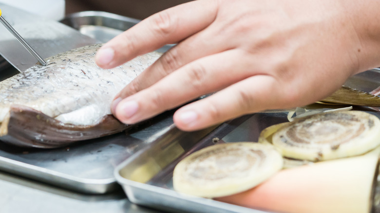 Chef testing fish temperature