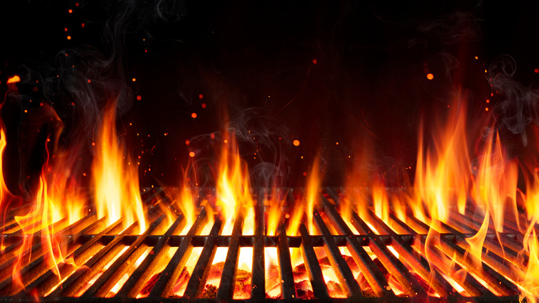 Flames rising through grill grate