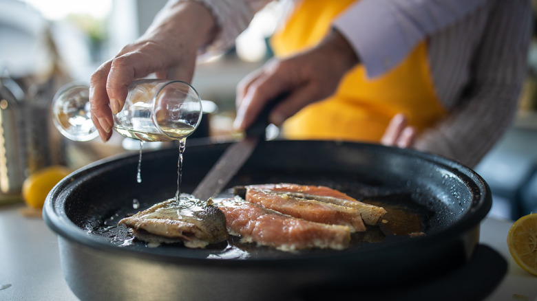 Pouring a bit of wine into a pan