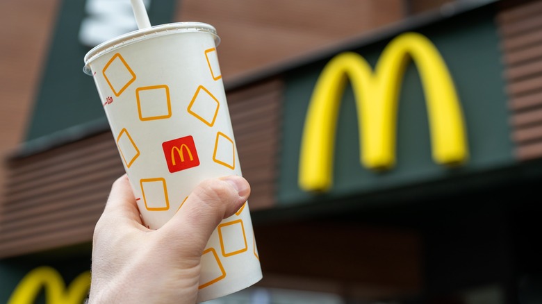 customer holding McDonald's beverage