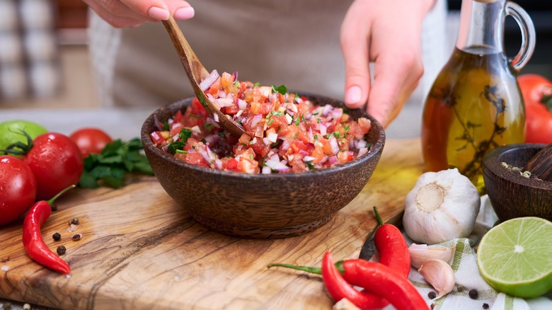 stirring bowl of salsa