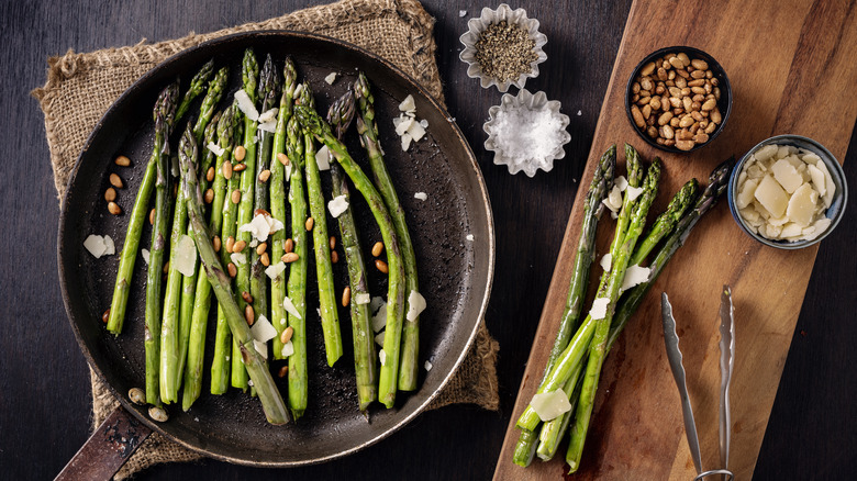 Pan fried asparagus topped with nuts and cheese