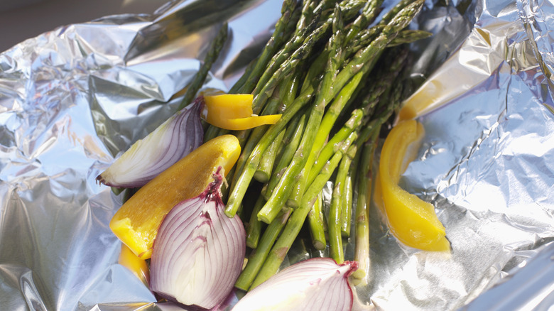 Asparagus, yellow bell pepper, and onion wrapped in foil