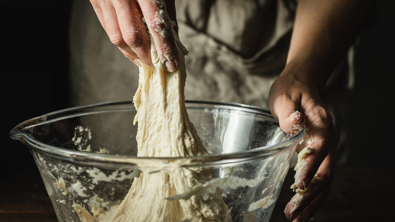 Kneading dough in glass bowl