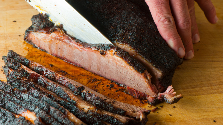 Knife slicing barbecue brisket