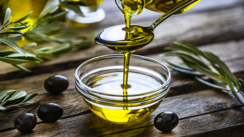 Pouring olive oil into a bowl