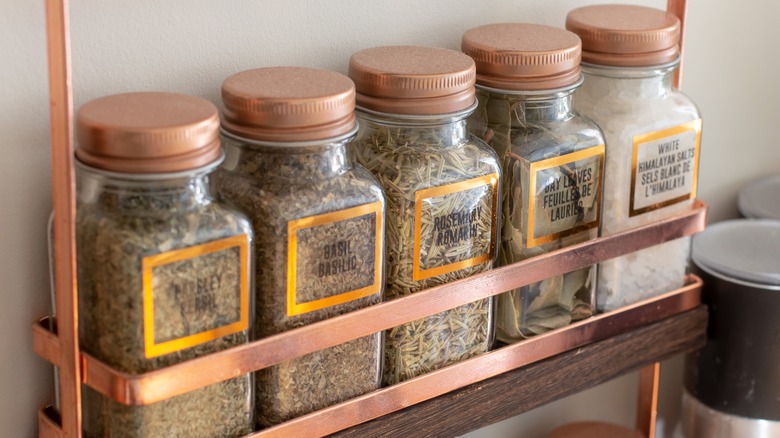 Dried herbs stored in glass bottles