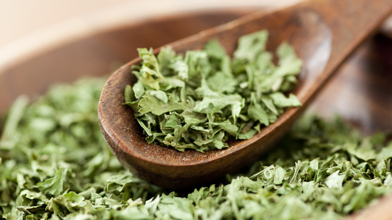 Dried parsley in wood spoon