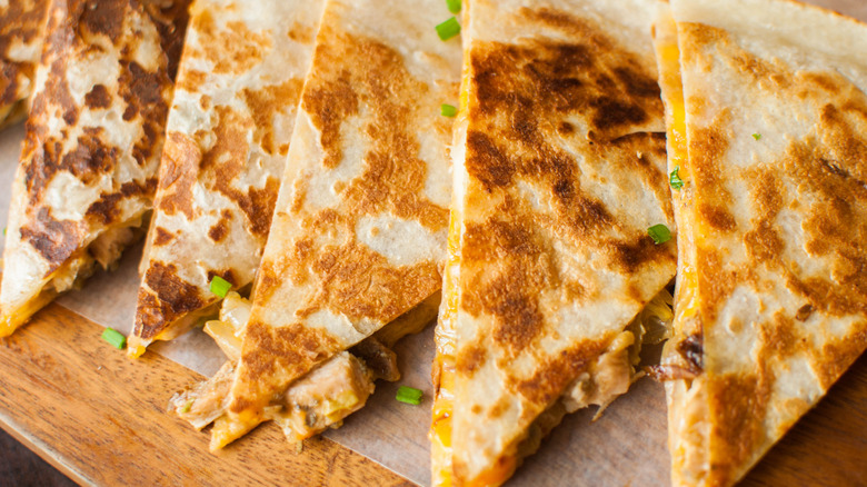 Quesadilla triangles on a board with parchment