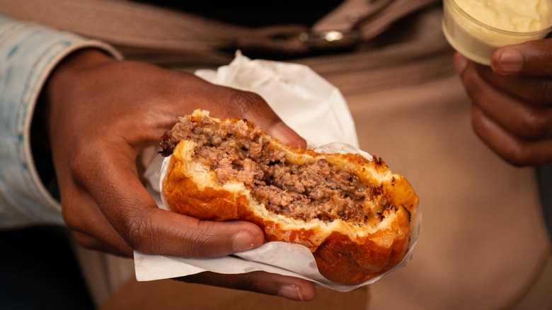 Hand holding a half-eaten Smashburger