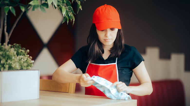 fast food staff holding rag