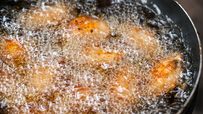 Frying chicken in pan