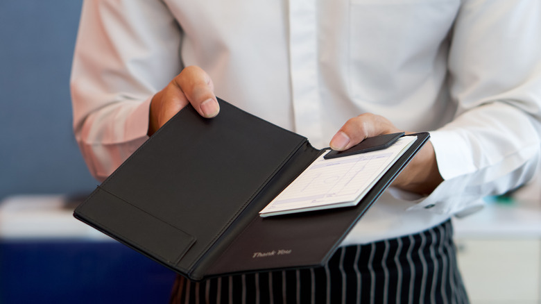 Waiter holding a checkbook