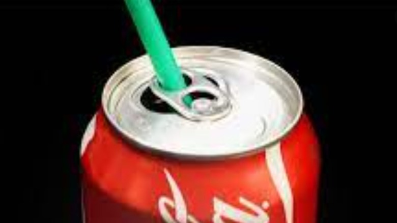 Soda can with straw