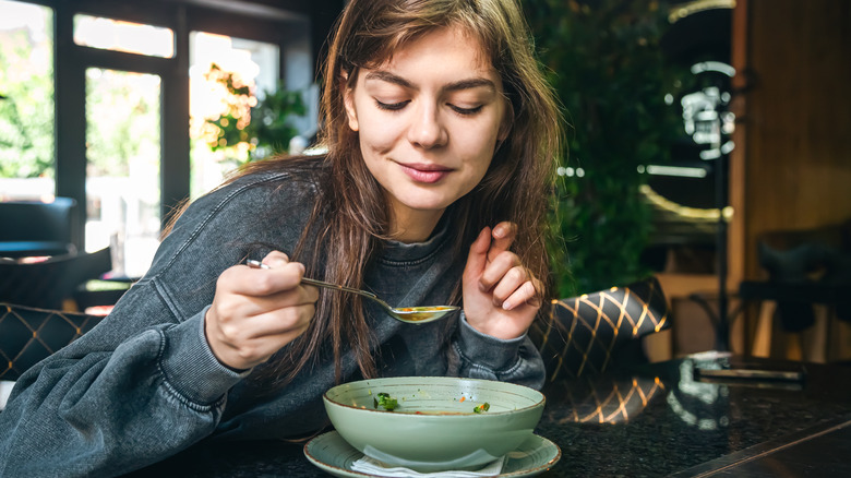 Woman eating soup