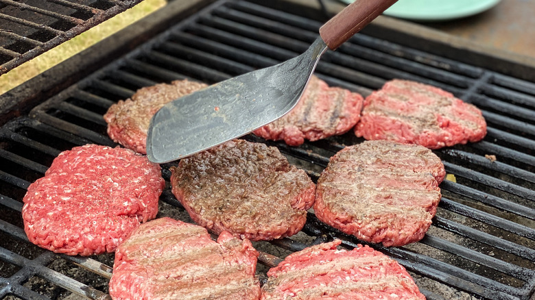 Spatula flipping a burger