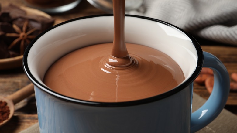 Pouring thick hot chocolate into a mug